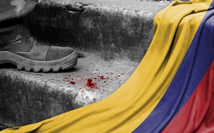 A military boot on concrete steps with blood stains and a Colombian flag draped nearby