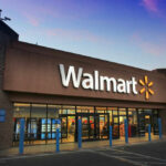 Walmart storefront at dusk with lit signage