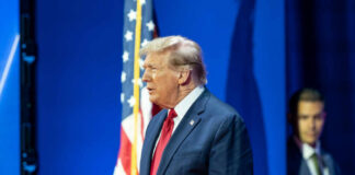 Man in suit with American flag background