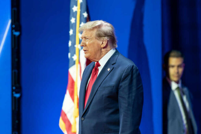 donald-j-trump-arrives2429741179jpg Man in suit with American flag background