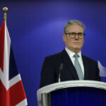 Brittle Bonds: Trump Exposes U.K. Alliance Cracks Man in suit at a podium, British flag behind.