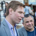 Two men engaged in conversation at a public event