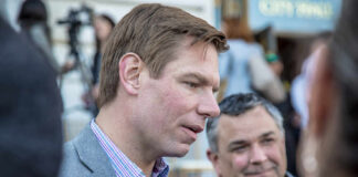 Two men engaged in conversation at a public event