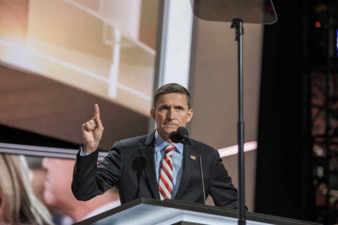 A speaker gesturing while addressing an audience at a conference
