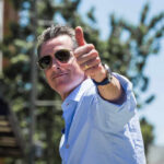 Media Backlash: Newsom’s Beauty Over California Crises Man giving a thumbs up while wearing sunglasses