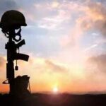 Seventh Hero FALLEN – U.S. Losses Mount Silhouette of a soldier's helmet and rifle against a sunset