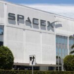 Exterior view of the SpaceX headquarters building with a speed limit sign