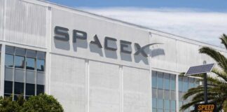 Exterior view of the SpaceX headquarters building with a speed limit sign