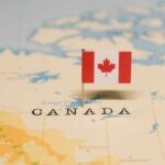 IRGC Network in Canada? What’s The TRUTH? A small Canadian flag pinned on a map indicating Canada