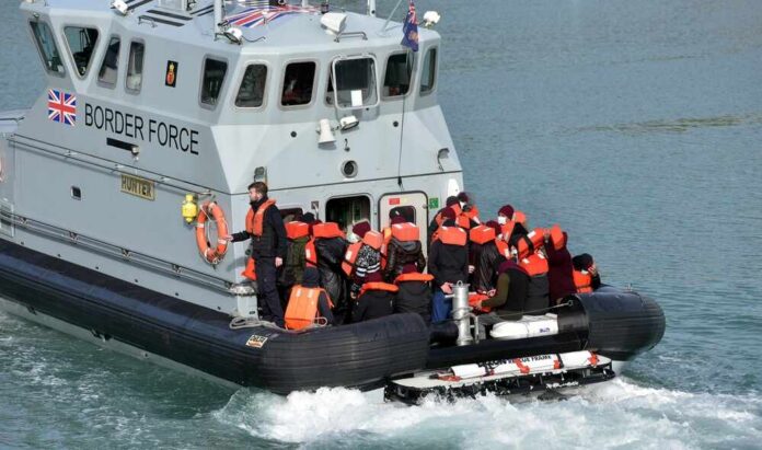 Border Force boat with migrants wearing life jackets