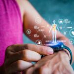 Person using a smartwatch displaying health data and holographic graphics