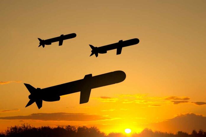 Silhouettes of missiles flying against a sunset backdrop