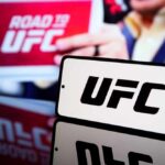UFC logo displayed prominently with a blurred background of a promotional sign