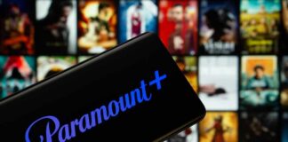 Mobile device displaying the Paramount Plus logo with a movie selection in the background