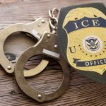Afghan Ally Dies in ICE Custody: Urgent Questions Handcuffs and a police badge on a wooden surface