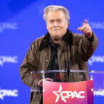 Person speaking at CPAC conference blue background
