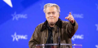 Person speaking at CPAC conference blue background