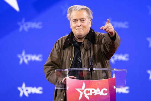 Person speaking at CPAC conference blue background