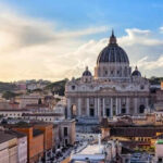 St Peters Basilica with surrounding cityscape at sunset