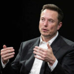 Man in suit gesturing during a conversation