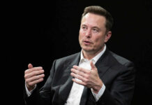 Man in suit gesturing during a conversation