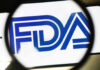 FDA logo under a magnifying glass.
