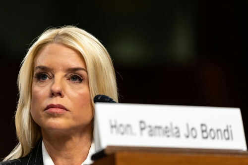 Woman seated next to nameplate at event