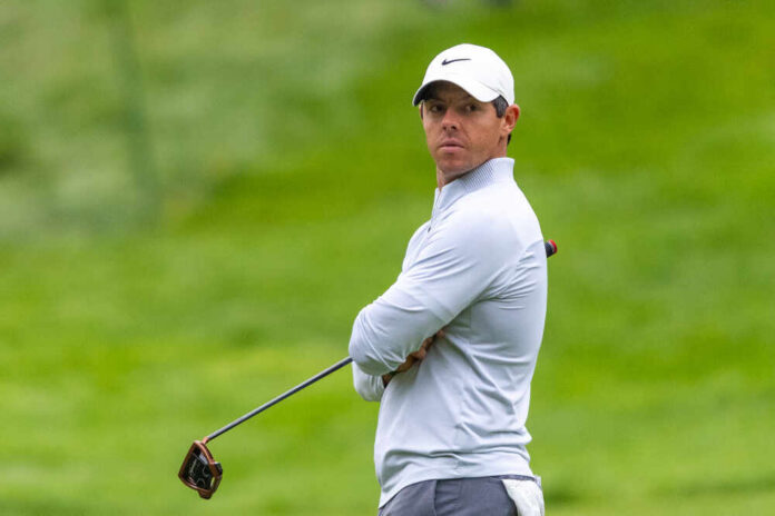 A golfer in sportswear looking intently on the golf course