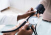 A healthcare professional measuring a patient's blood pressure
