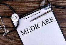A document labeled 'Medicare' with a stethoscope and magnifying glass on a wooden surface