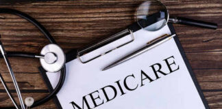 A document labeled 'Medicare' with a stethoscope and magnifying glass on a wooden surface