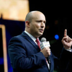 A speaker delivering a speech with a microphone in hand