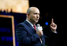 A speaker delivering a speech with a microphone in hand
