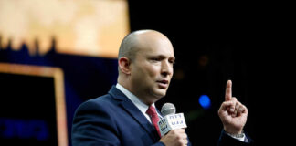 A speaker delivering a speech with a microphone in hand