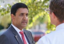 Two professionals engaged in conversation outdoors