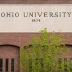 Sign of Ohio University displayed on a brick building