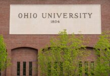Sign of Ohio University displayed on a brick building