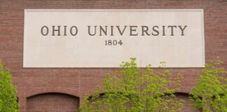 Sign of Ohio University displayed on a brick building