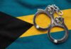 Handcuffs resting on the flag of The Bahamas