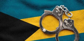 Handcuffs resting on the flag of The Bahamas