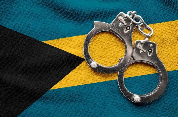 Handcuffs resting on the flag of The Bahamas
