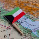 Small flag of Kuwait placed on a map of the Middle East
