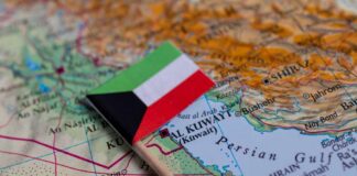 Small flag of Kuwait placed on a map of the Middle East