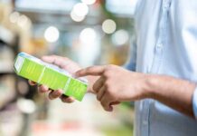 Person examining a product box in a store