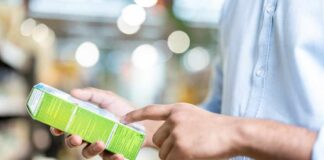 Person examining a product box in a store