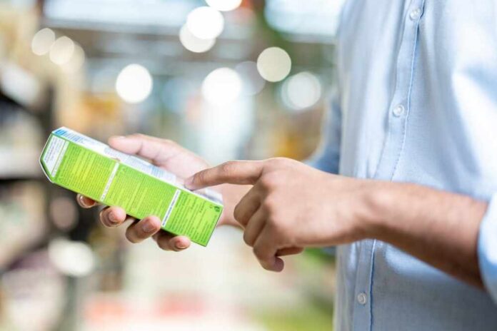 Person examining a product box in a store