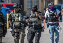 Group of police officers in tactical gear walking in an urban area