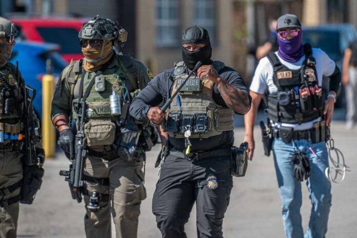 Group of police officers in tactical gear walking in an urban area