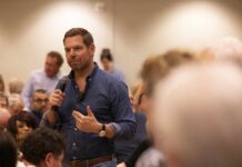 A speaker addressing an audience at a community event