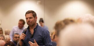 A speaker addressing an audience at a community event